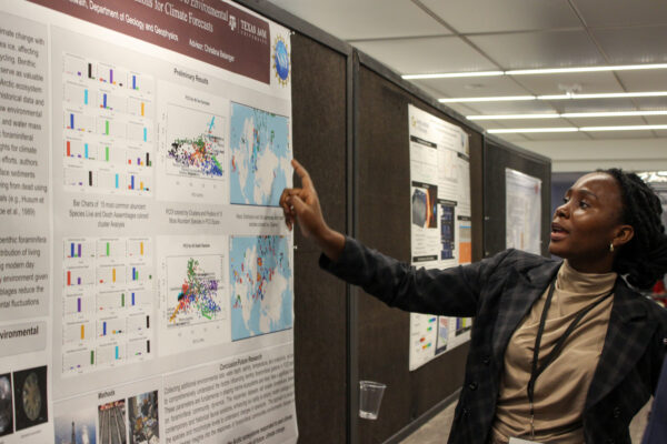 Black Geoscientist Presenting Technical Work at Conference in Poster Session